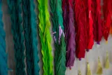 A close-up view of a few of the colourful, folded paper cranes that are part of an installation consisting of one thousand cranes.