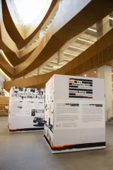 A large building featuring an expansive open space, showcasing its impressive architecture and design. In this space, there are two standalone informational displays from the “Love in a Dangerous Time” pop-up exhibition developed by the Canadian Museum for Human Rights.