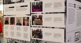 A close-up of a display cube which bears, on one side, the headline “After the Purge” under which four photos of men are arranged with lines of small text beneath. Another section has three larger photos arranged vertically. The images indicate they are a Black Lives Matter Toronto march, a protest in support of trans kids, and an Indigenous Two-Spirit demonstration. The second side of the cube has a headline “Change is Possible: 2SLGBTQ+ Activism.”