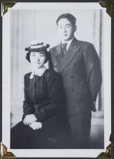 A young woman and a young man pose in formal wear.