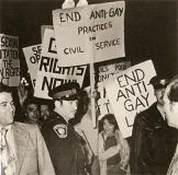 Crowd of people holding signs at a demonstration.