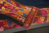 A closeup of a colourful embroidered fabric. The pattern is a traditional Palestinian embroidery called tatreez.