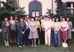 A group of Indigenous women nurses stand together outside.