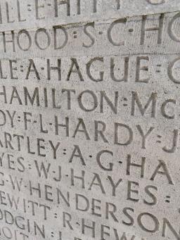 Close-up of many names carved into grey stone in capital letters. The only complete name, visible at the centre, is “F L HARDY.”