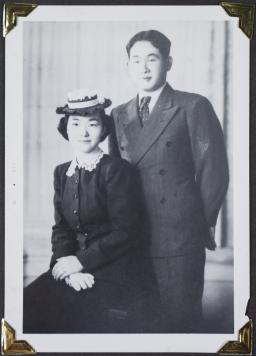 A young woman and a young man pose in formal wear.