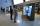 A man and woman stand looking at a double-sided video screen in a museum gallery. The man is pointing at the screen.