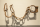 Rusted iron manacles hang on hooks on a plain white wall.