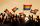 Several hands reaching toward a sunlit sky, with many waving rainbow flags.