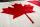 A close-up image of a Canadian flag, with a focus on the red maple leaf.