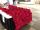 Two people are working at a table full of poppies.