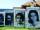 Outdoor display of large photographs of people’s faces.