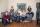 A smiling family of six in a living room.
