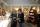 Two women look at a piece of jewellery. They are standing in a store full of colourful merchandise.