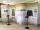 An exhibit of four floor-to-ceiling curved panels covered with photos and text, behind two iPad stands.
