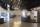 A museum display consisting of curved couches, video screens, and larger-than-life photos of diverse people.