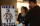 Two people looking at a poster.