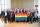 Twenty-eight members of the LGBT Purge Fund Board and LGBTQ2+ National Monument Advisory Committee standing together and holding a rainbow flag, at the first Monument visioning session in 2019.