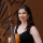 Headshot of Sonia Lazar holding a violin