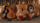 Several restored violins are pictured leaning on each other in a pile. Each of the violins carry at least one Star of David