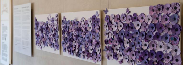 Purple poppies made of paper with names and messages from community members and family of those who have died as a result of a poisoned drug supply.