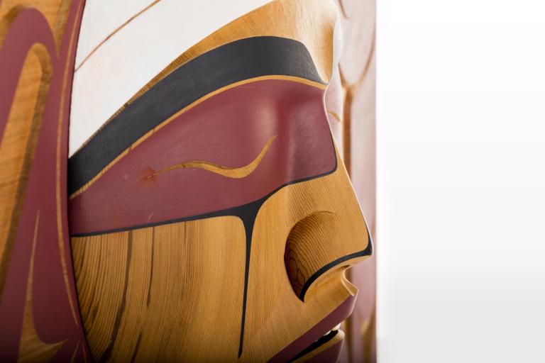 Carved wooden face Partially obscured.