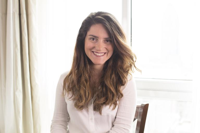 A woman looking at the camera smiling.