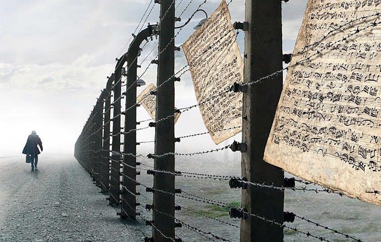 A person walking by a barbed-wire fence. Sheet music is caught in the wire. Partially obscured.