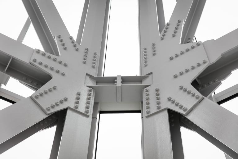 Close-up of large steel beams Partially obscured.