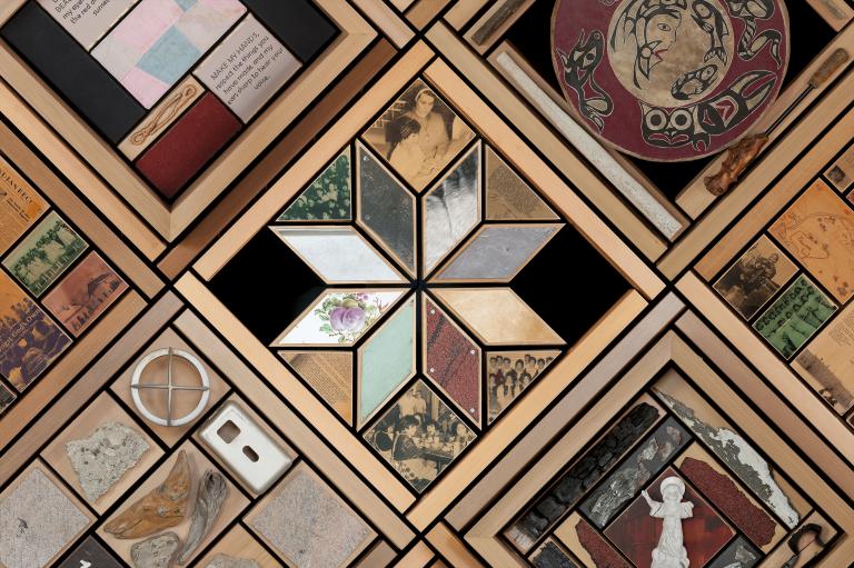 Portion of a large artwork consisting of objects set in cedar frames. Partially obscured.