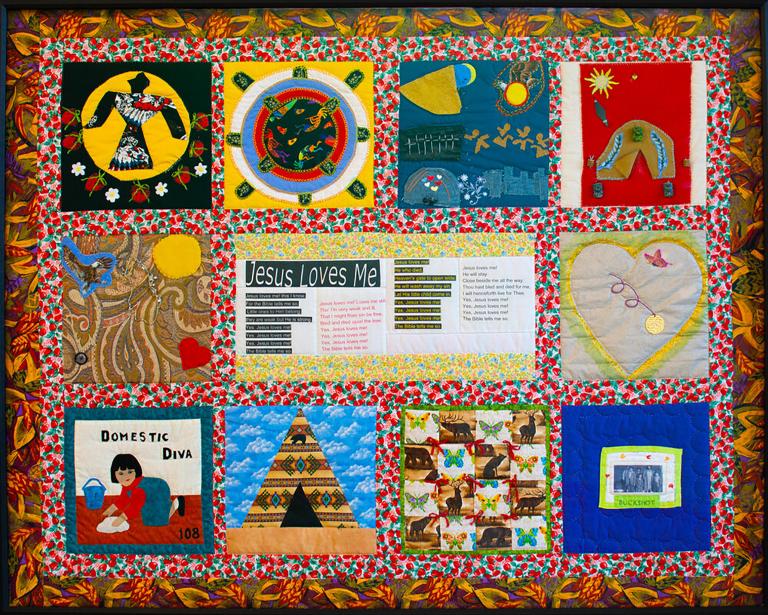 A colourful quilt with varied panels, including designs such as a bird, a heart, a teepee, a woman cleaning a floor, and lines of text under the title “Jesus Loves Me.”