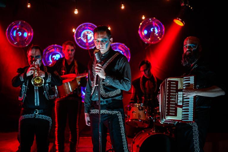 The Mariachi Ghost band members, dressed in traditional Mexican mariachi outfits and makeup. Partially obscured.