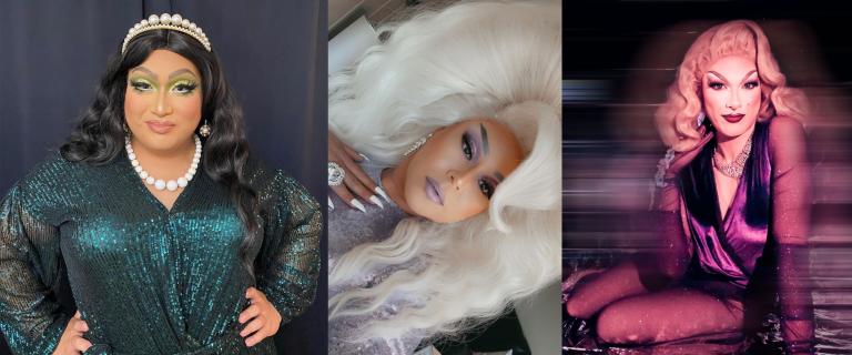 Drag queen with long, wavy black hair wears a tiara and necklace with large white pearls and a glittery emerald green dress. Drag queen with big platinum-blond hair is dressed in a silver, sequined dress. Drag queen with shoulder-length blond hair sits wearing a purple velvet dress. Partially obscured.