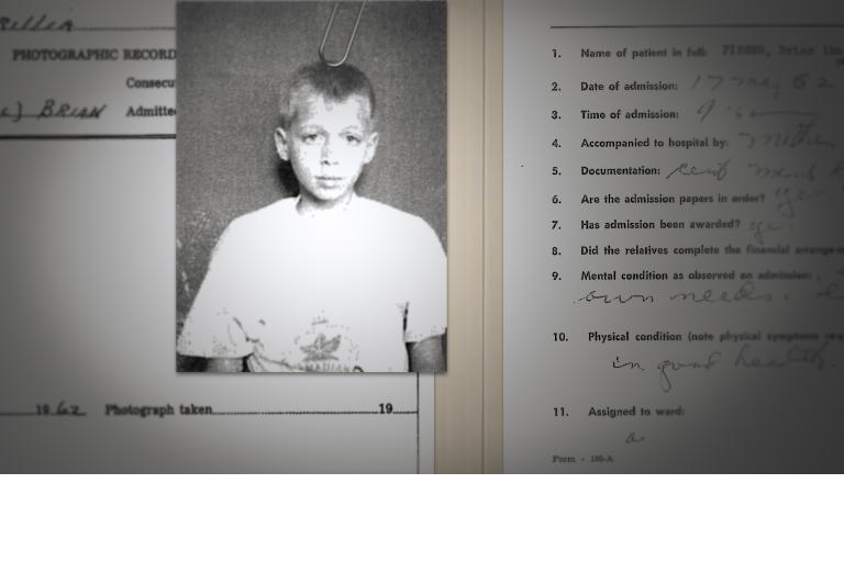 A black-and-white photo of a sad-looking boy is paperclipped to an institution admission form that asks his name, when he was admitted, and his mental condition. Partially obscured.