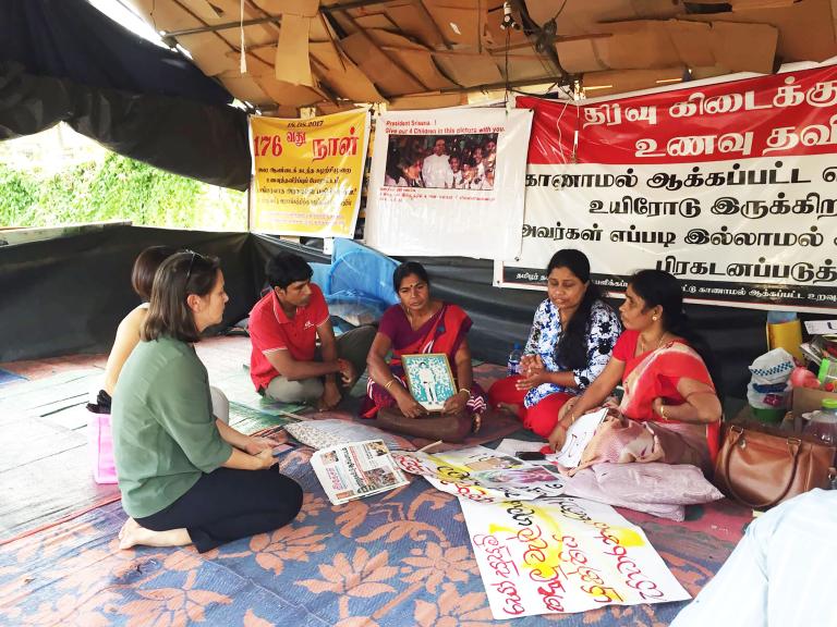 In the Sri Lankan city Vavuniya in 2017, Elaine Pearson meets with Tamil mothers protesting the enforced disappearance of their children during Sri Lanka's civil war. Partially obscured.