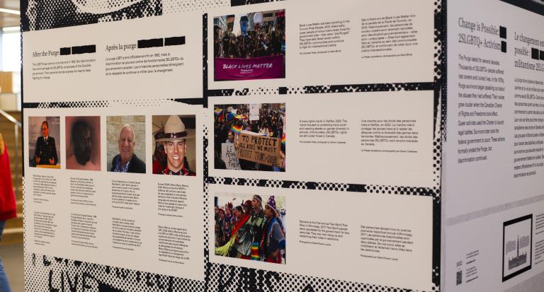 A close-up of a display cube which bears, on one side, the headline “After the Purge” under which four photos of men are arranged with lines of small text beneath. Another section has three larger photos arranged vertically. The images indicate they are a Black Lives Matter Toronto march, a protest in support of trans kids, and an Indigenous Two-Spirit demonstration. The second side of the cube has a headline “Change is Possible: 2SLGBTQ+ Activism.”