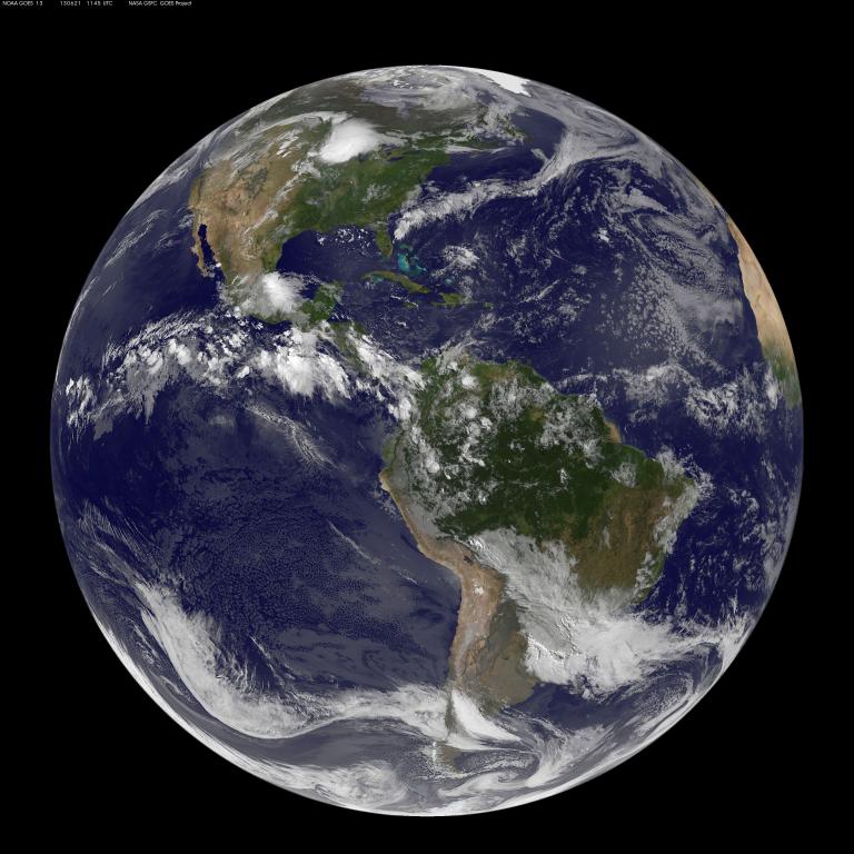 A full view of Earth from space centred on North and South America, with swirling white clouds over blue oceans and green/brown landmasses. Partially obscured.